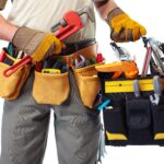 Handyman with a tool belt. Isolated on white background.